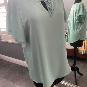 Women’s light green blouse.